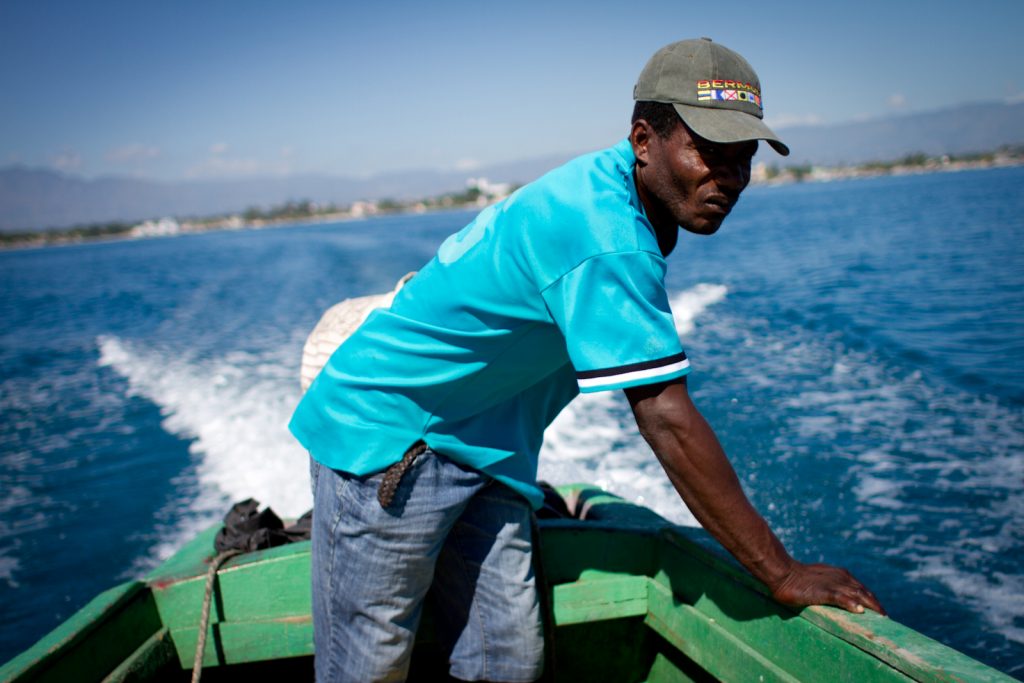 In this December 2014 photo, a man navigates his boat toward an island off Haiti's Southern peninsula -- the area area hardest hit by Hurricane Matthew this month. (Photo by Jacob Kushner and used here with permission)