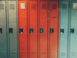 This image shows a series of school lockers in aqua and red.