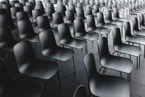 Black and white image of empty chairs in an auditorium